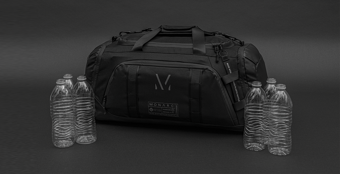 monarc travel duffel backpack surrounded by plastic bottles