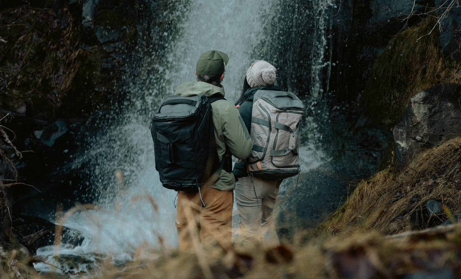 Two people wearing monarc duffel bags